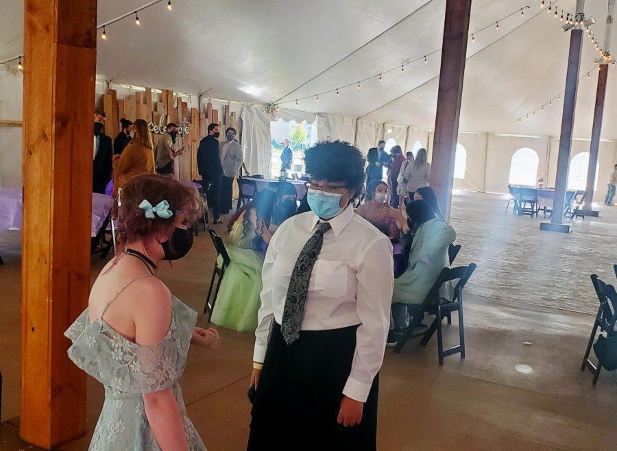 Sarah Stuenkel and Mackenzie Gore converse at the socially distanced senior prom that the school sponsored. 