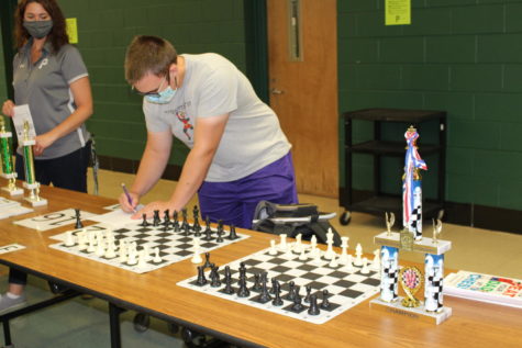 Senior, Simon Snydersmith, studies the board at the chess team table.