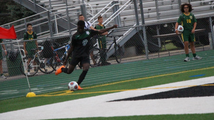 Moses Mata, senior, delivers a corner kick to a teammate to set up a goal attempt.