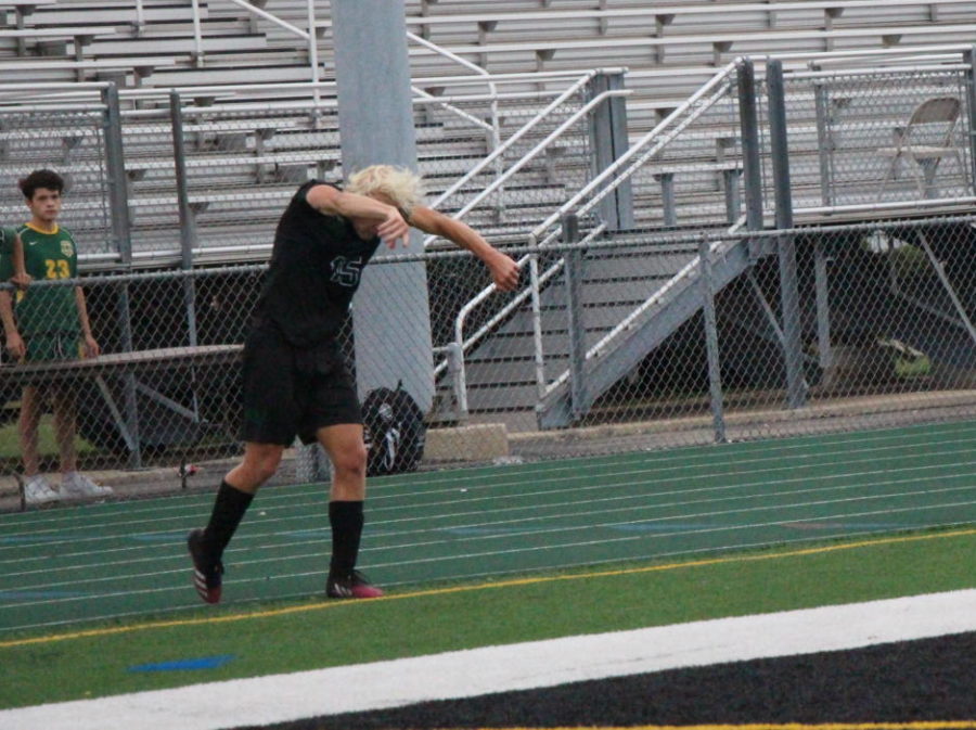 Cooper Bartz, junior, launches the ball to a teammate during his throw-in late in the game.