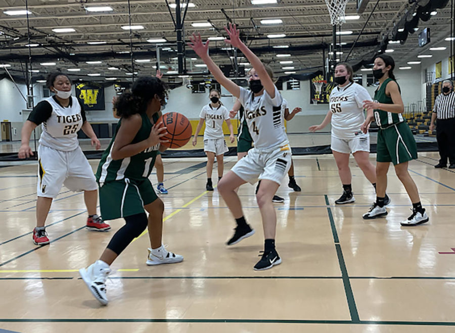 Freshman Brianna Ashford tries to avoid a defender on Nov. 30 when varsity, JV and freshmen teams all took on Joliet West and were defeated.