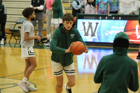 Luke Cervelli, senior, passes in warmups before the Wildcats were defeated by Joliet West 55-49.