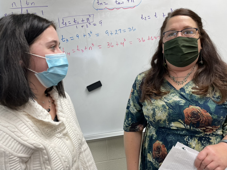 Tessa Danko, junior, hands Lynda Clark,math teacher, a hand-written letter for her upcoming retirement.