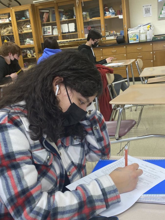 Ileen Montoya, junior, wears headphones during independent work. 97% of students feel headphones should be allowed while working.