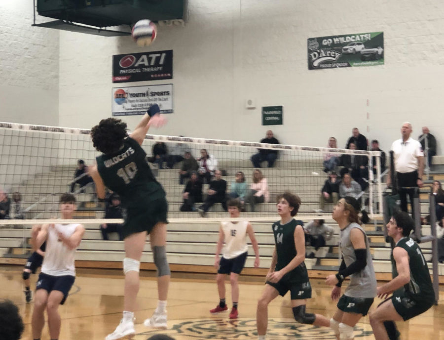 Sophomore Gavin Gonzalez jumps to spike the ball against Nazareth