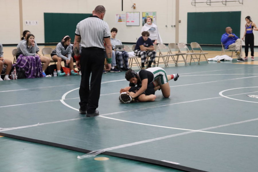 Sophomore Alicia Tucker uses a takedown against her Kaneland High School opponent at Plainfield Central on Saturday, Dec. 10.