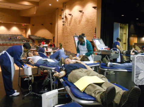 Red Cross nurses  monitor students as they donate blood to assist those who need transfusions. 