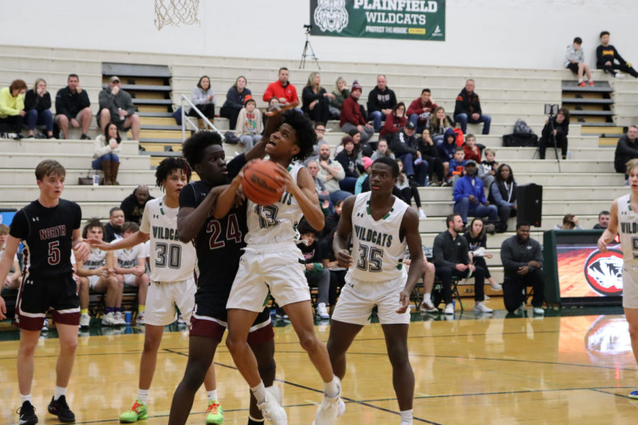 Junior Zakar Finch is fouled attempting a layup against the Plainfield North Tigers on Jan. 20 at home.