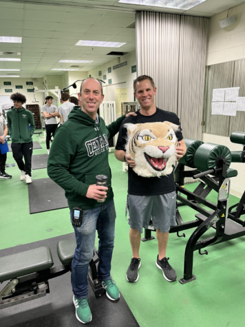 Dave desGarenes passes to Wildcat award to Gregg Bayer, PE teacher.