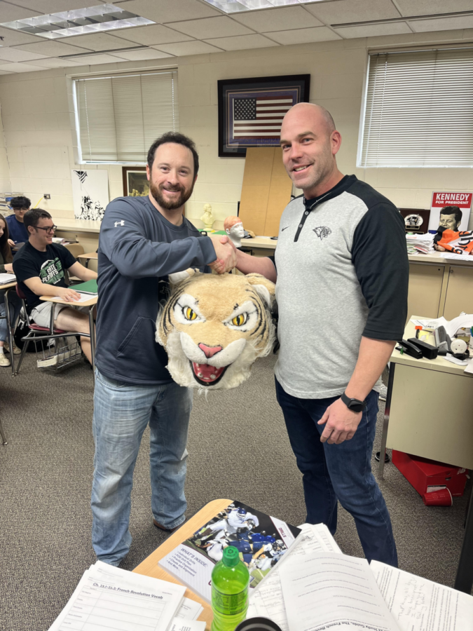 Greg Proctor passes the Wildcat Award to Coach Rob Keene.