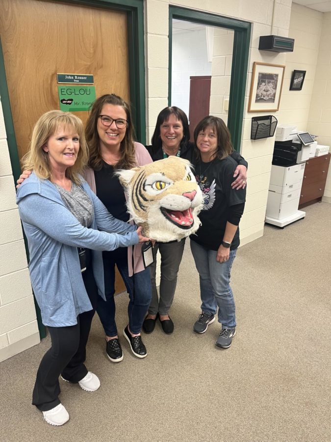 Pat Maher passes the Wildcat Award to the entire attendance office staff: Val Zawistowski, Tracy Prah, and Cindy Osborn.