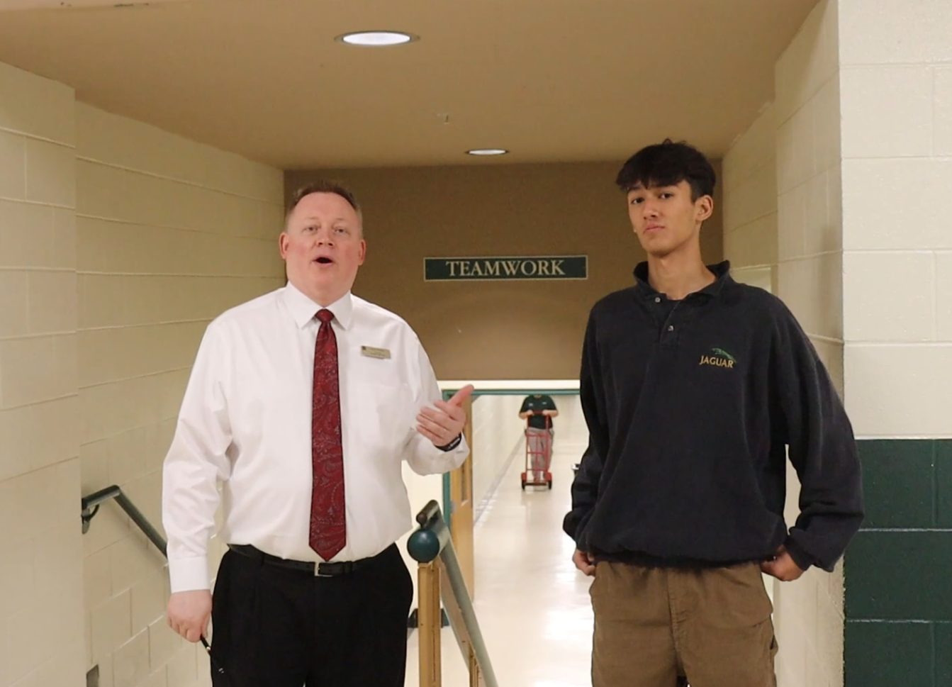 School principal, Chris Chlebek, explains what the E Hallway is used for during Diego Cambrays campus tour.
