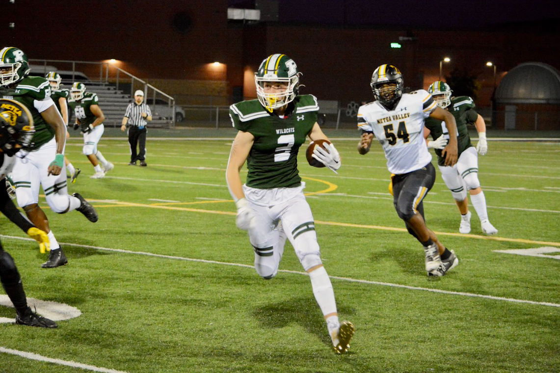 Max Russell runs the ball, dodging Matea Valley defense.