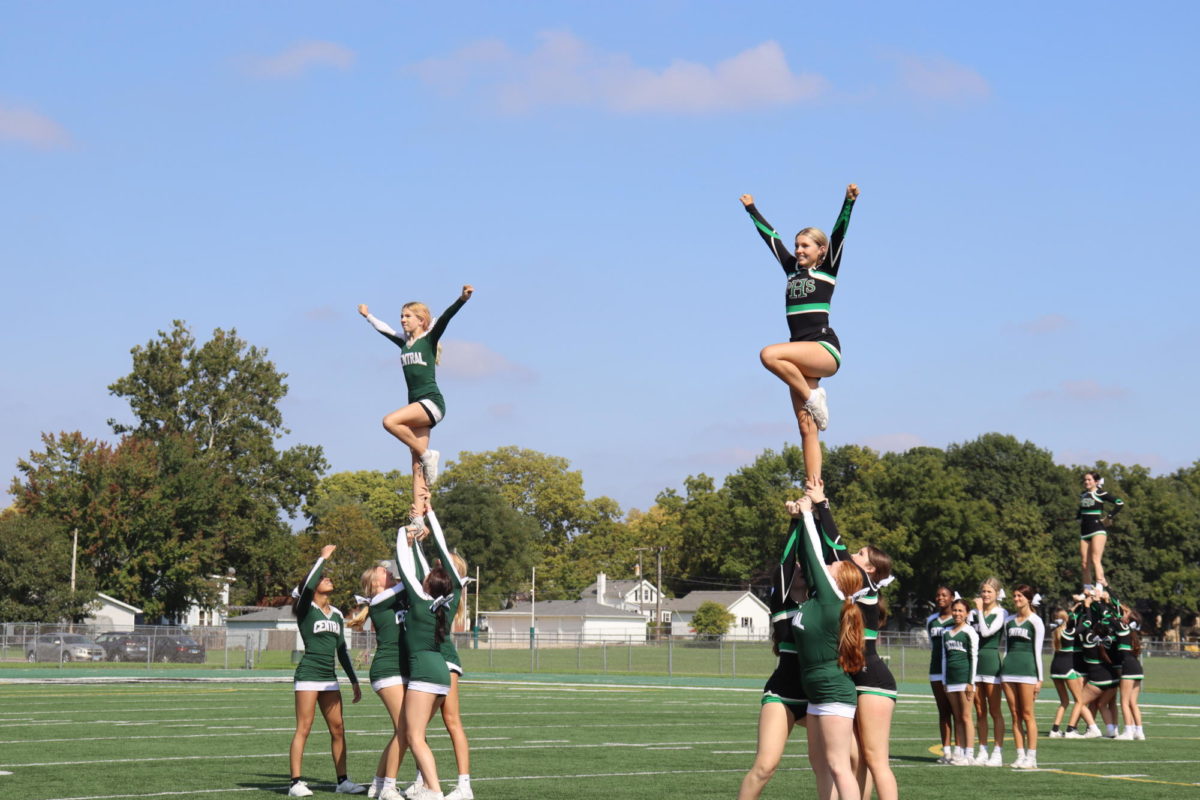 The JV and varsity cheerleaders preform together for the students.
