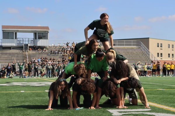 Senior Allyson Botzum finalizes the pyramid, winning the event for the seniors.