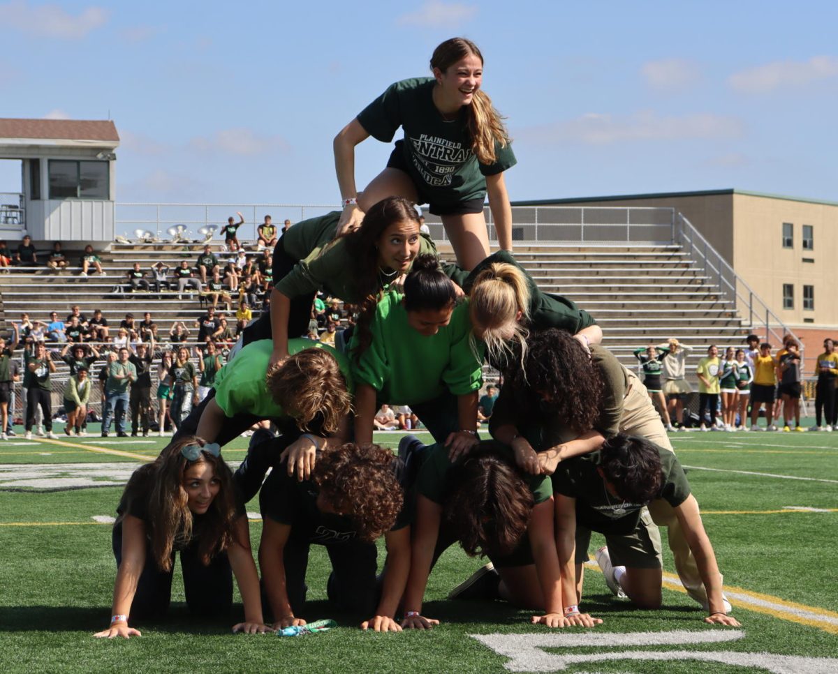 The annual homecoming pep rally begins with class competitions. Senior Allyson Botzum finalizes the pyramid, winning this event for the seniors.