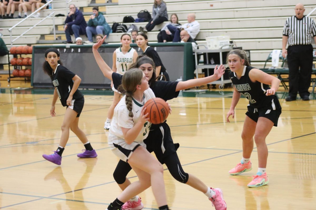 Freshman Serenity Palacios shoots around the JV defender at the Green and White scrimmage night.