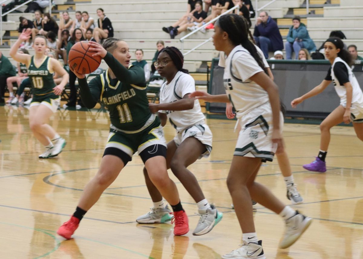 Aniela Machaliski, senior, attempts to pass around the freshman defender at Green and White night on Nov. 19. The varsity team won the scrimmage.