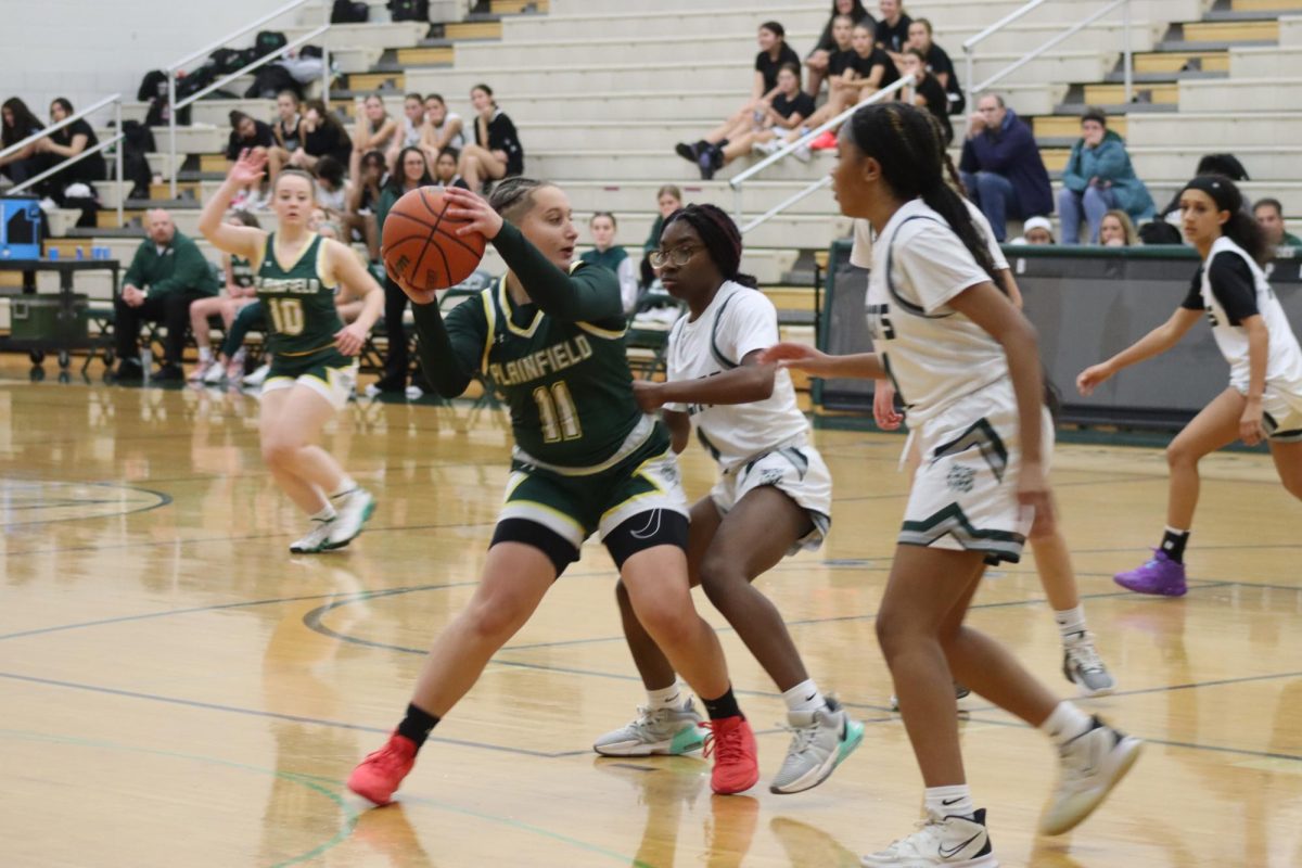 Aniela Machalski, senior, attempts to pass around the defender at the Green and White night scrimmage on Nov. 10. 