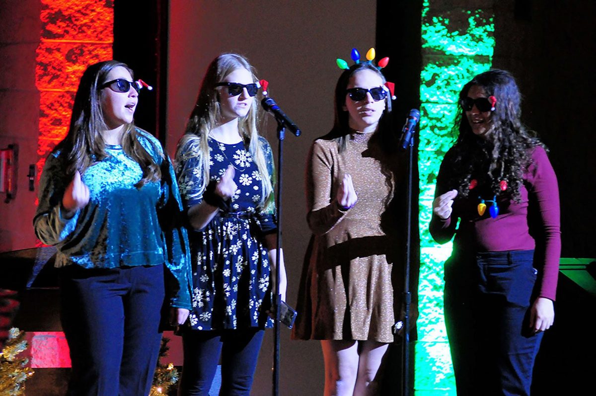 Seniors Sabrina Rodriguez and Becca Cameron perform at last year's collage concert with alumni.