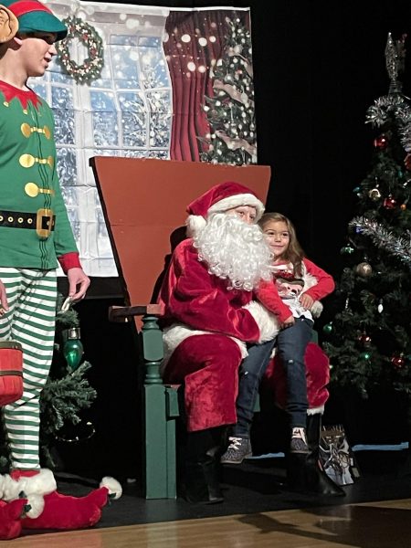 Senior Reese Boekeloo plays Santa at the fundraiser.