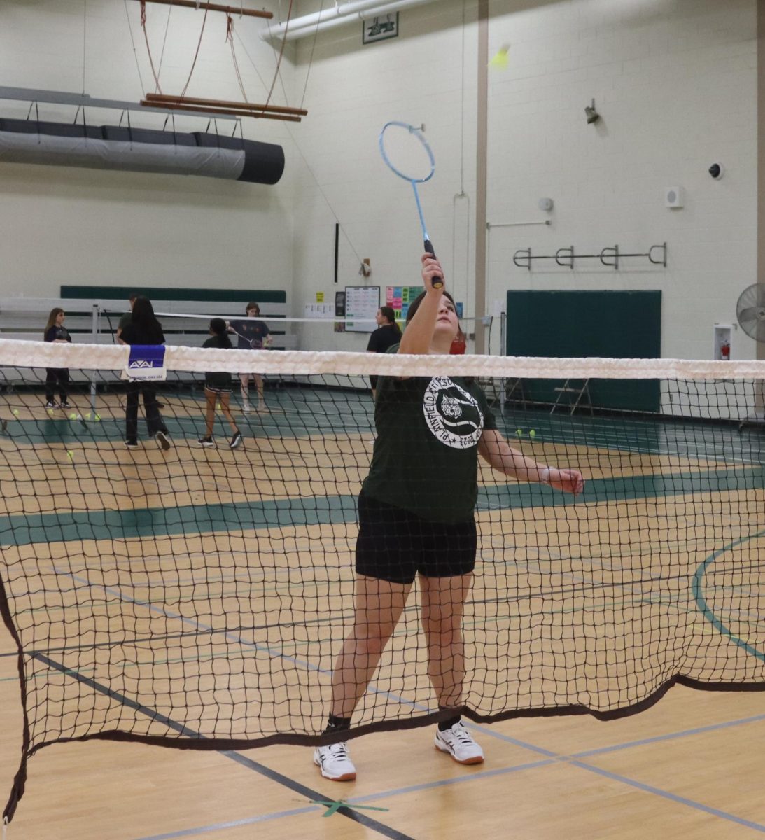 Tiffany Radaker, senior, smashes down the birdie at a practice. 