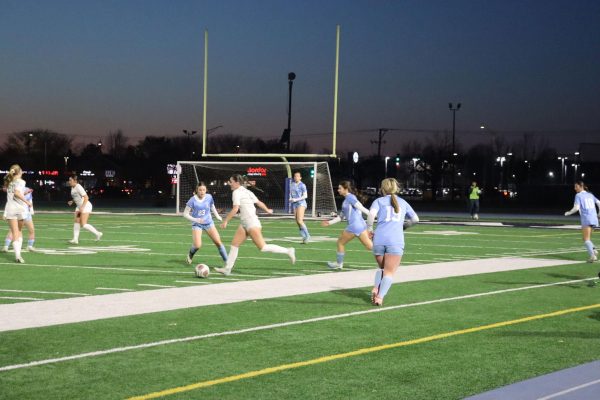 Ava Lambert, sophomore, passes the ball down field during their 7-0 victory against Joliet 
Catholic Academy, on Monday, March 17.