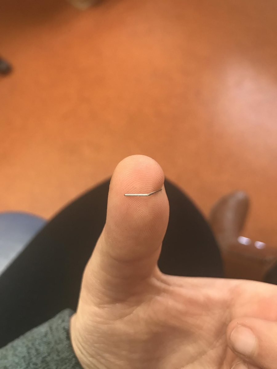 Nicole Jensik, physics teacher, takes ‘hands-on’ teaching to new levels after a run in with a stapler.