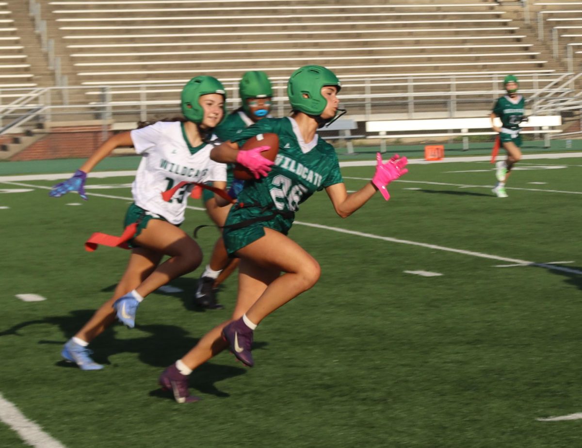 Sophomore Sophia Heyl attempts to catch freshman Victoria Mota at Green and White night.