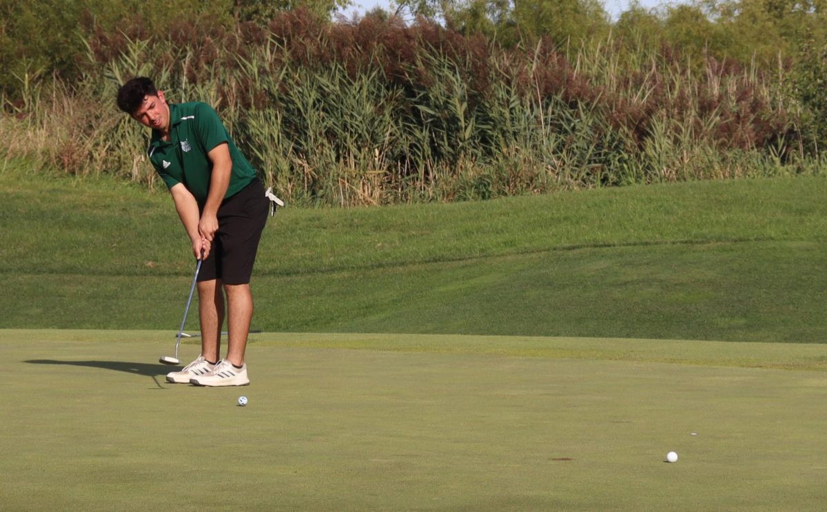 With full concentration, sophomore Damian Maxwell prepares for a crucial putt against Yorkville on Sept. 9 during senior night. It was a close match with a final score of 171 to 152.