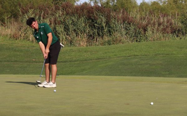 With full concentration, sophomore Damian Maxwell prepares for a crucial putt against Yorkville on Sept. 9 during senior night. It was a close match with a final score of 171 to 152.