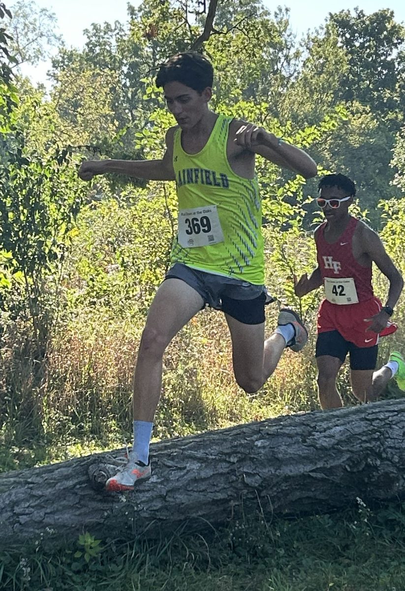 Junior Spencer Kazak strides over a log in the final stretch at
Lincoln Way Central Boys invite, on Sept. 27.