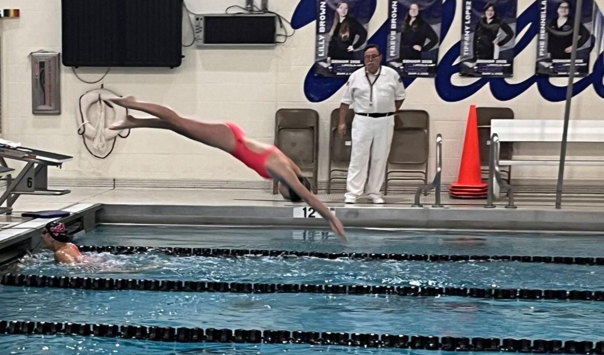Mia Ceballos, senior, dives off the block to begin her leg of the 200m relay event during the meet against Lincoln Way East on Oct. 14.
