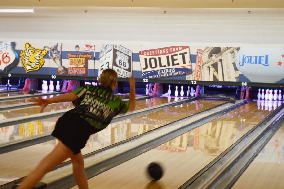 Payton Henderson, senior, bowls a strike at the Town & Country Lanes on Nov. 28. She ended with a 596 series which was the top score for the team.