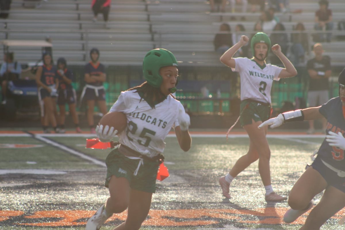 Shania Davison, junior, runs the ball for a first down against the Romeoville Spartans on Aug. 27.