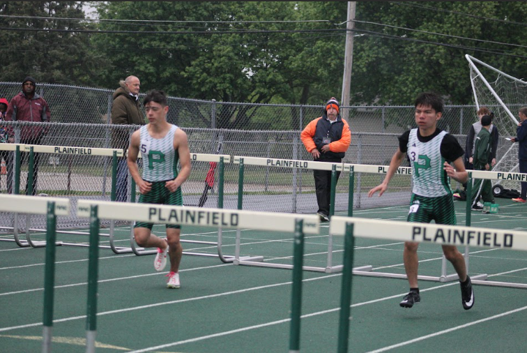 Giulian Salas, senior and Jonathan Solano, freshman, compete in the hurdles at the meet.